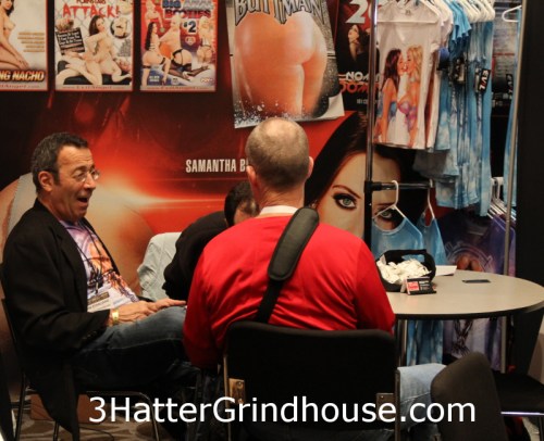 Chatting with John, clothing on display in the background. Photo by Bill Knight