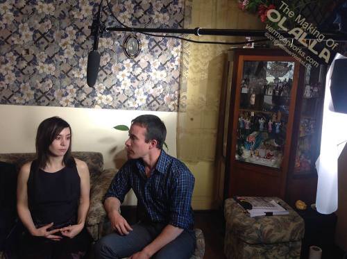 Olalla and Nathan talk among the images within the cabinet.